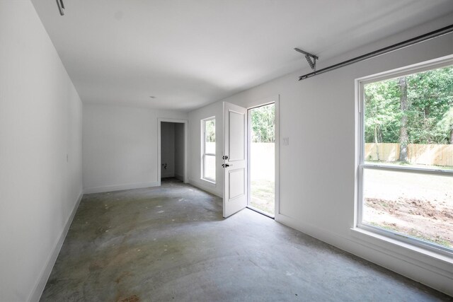 8703 Miller Rd, Magnolia, TX 77354 - unfurnished room featuring concrete floors and healthy amount of natural light