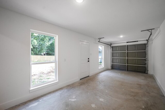 8703 Miller Rd, Magnolia, TX 77354 - garage featuring baseboards and recessed lighting