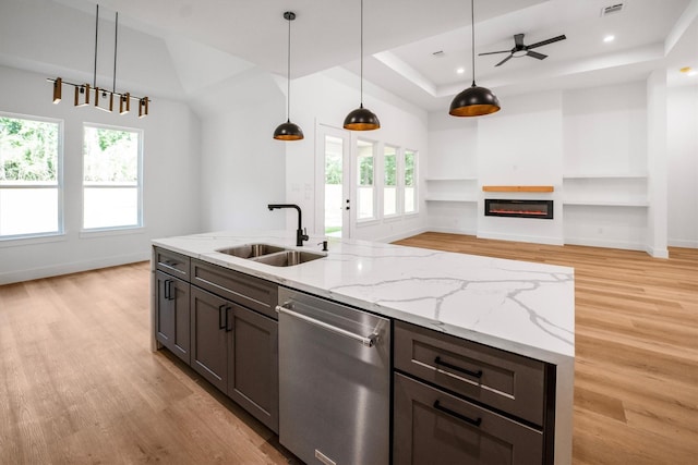 8703 Miller Rd, Magnolia, TX 77354 - kitchen with dishwasher, a tray ceiling, light wood-type flooring, plenty of natural light, and recessed lighting