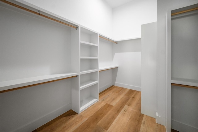 8703 Miller Rd, Magnolia, TX 77354 - spacious closet featuring wood finished floors
