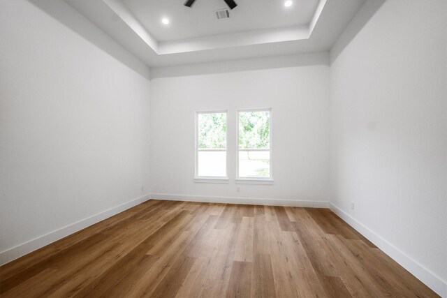 8703 Miller Rd, Magnolia, TX 77354 - unfurnished room featuring a tray ceiling, wood finished floors, a ceiling fan, and recessed lighting