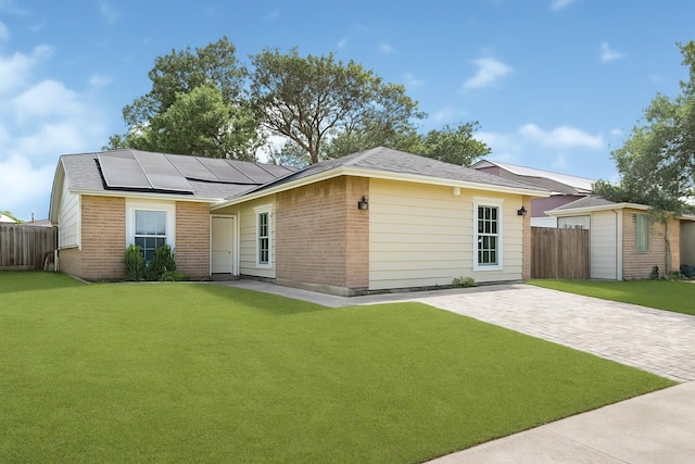 3018 Windy Royal Dr, Houston, TX 77045 - back of property featuring roof mounted solar panels, brick siding, and a patio area