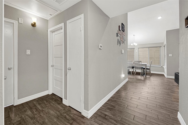 3018 Windy Royal Dr, Houston, TX 77045 - hallway featuring dark wood finished floors, attic access, and a chandelier