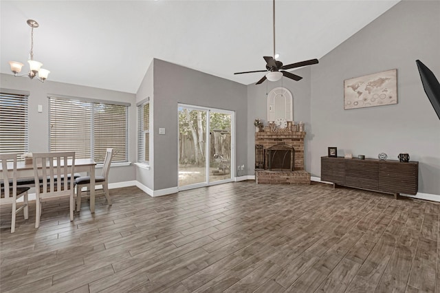 3018 Windy Royal Dr, Houston, TX 77045 - living room with a chandelier, wood finished floors, a brick fireplace, a ceiling fan, and high vaulted ceiling