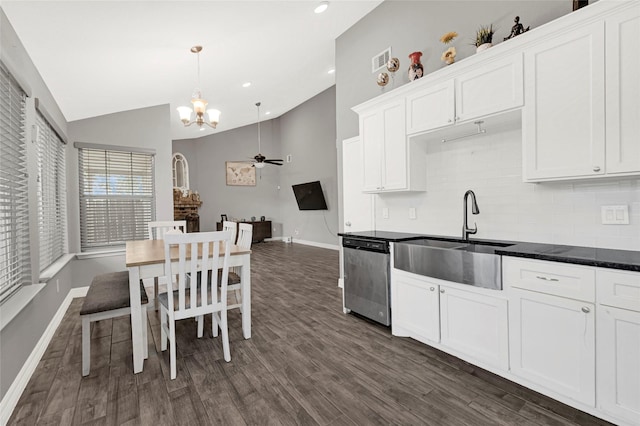 3018 Windy Royal Dr, Houston, TX 77045 - kitchen featuring stainless steel dishwasher, vaulted ceiling, a chandelier, white cabinetry, and backsplash