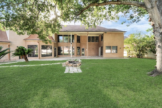 1743 Randons Point Dr, Sugar Land, TX 77478 - back of property with a patio area, a lawn, and stucco siding