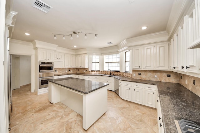 1743 Randons Point Dr, Sugar Land, TX 77478 - kitchen featuring crown molding, a center island, dark stone countertops, stainless steel appliances, and tasteful backsplash