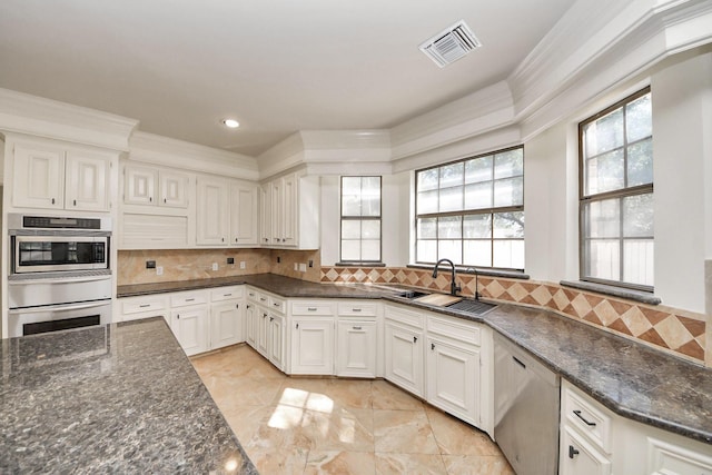1743 Randons Point Dr, Sugar Land, TX 77478 - kitchen with stainless steel appliances, ornamental molding, plenty of natural light, dark stone counters, and recessed lighting