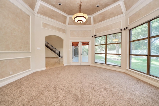 1743 Randons Point Dr, Sugar Land, TX 77478 - empty room featuring arched walkways, carpet floors, healthy amount of natural light, ornamental molding, and french doors