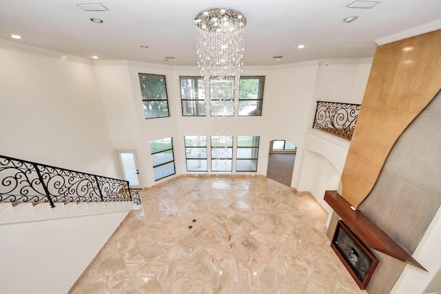 1743 Randons Point Dr, Sugar Land, TX 77478 - entrance foyer with a chandelier, ornamental molding, recessed lighting, a fireplace, and a towering ceiling