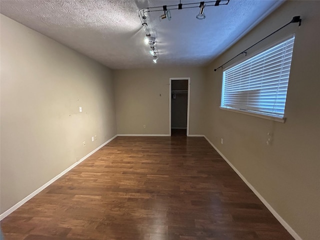 10007 Sagecourt Dr, Houston, TX 77089 - empty room featuring wood finished floors, rail lighting, and a textured ceiling