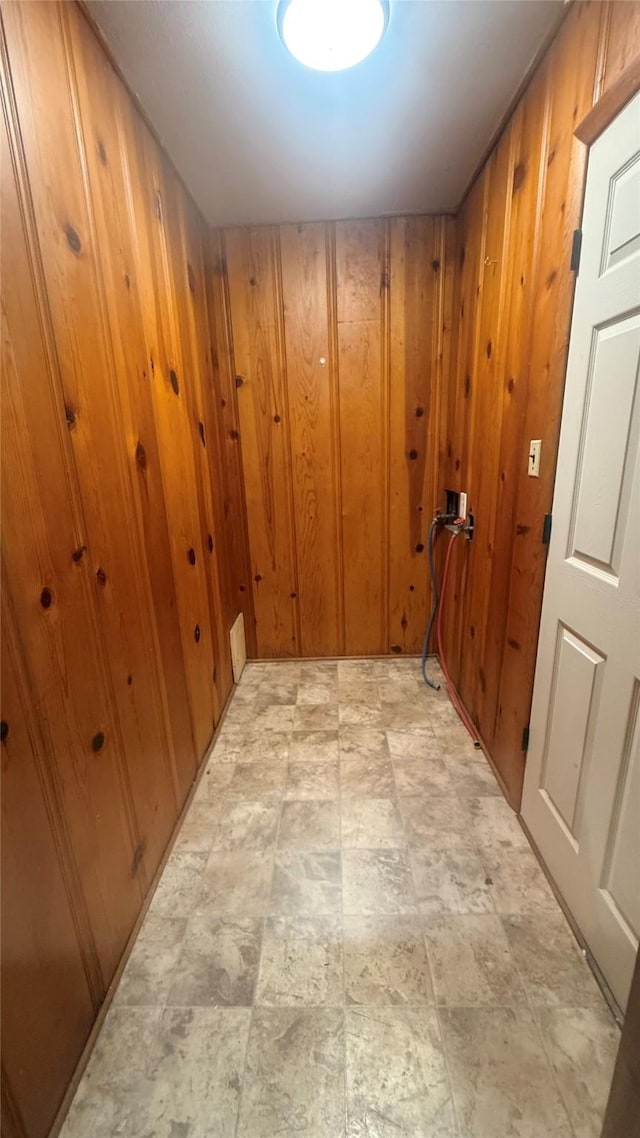 5580 Hooks Ave, Beaumont, TX 77706 - hall featuring wooden walls and stone finish floors