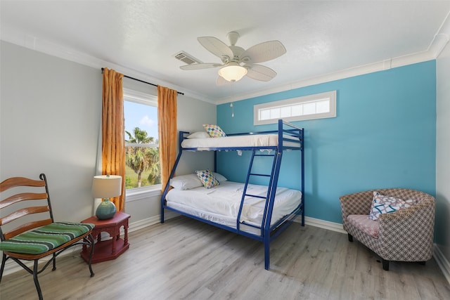 22517 Bay Point Dr, Galveston, TX 77554 - bedroom with wood finished floors, crown molding, and a ceiling fan