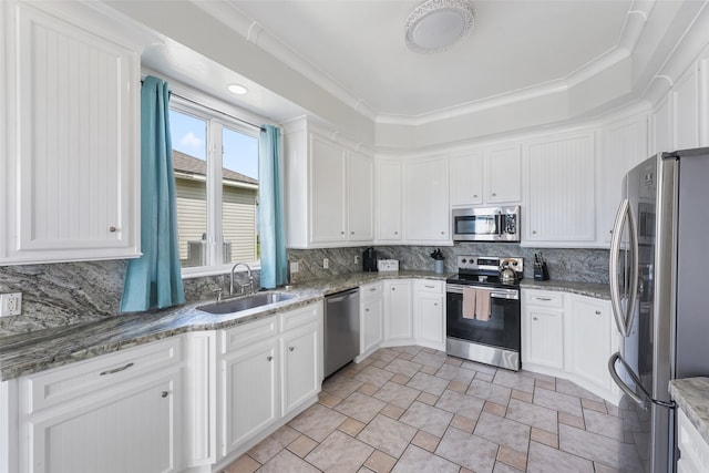 22517 Bay Point Dr, Galveston, TX 77554 - kitchen featuring appliances with stainless steel finishes, stone finish floors, backsplash, and white cabinets