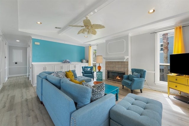 22517 Bay Point Dr, Galveston, TX 77554 - living room with light wood-style floors, a fireplace, a ceiling fan, recessed lighting, and crown molding