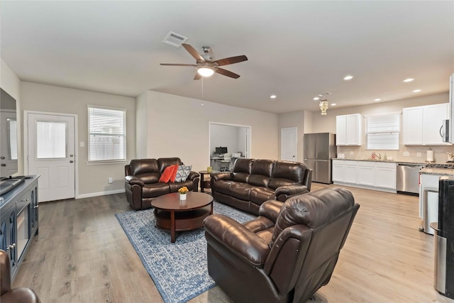 22006 Great Royal Ln, Houston, TX 77073 - living room with light wood-style flooring, ceiling fan, plenty of natural light, and recessed lighting