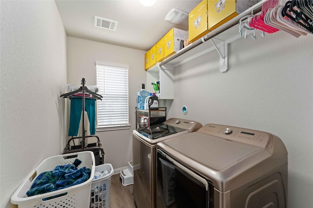 22006 Great Royal Ln, Houston, TX 77073 - laundry area with washing machine and clothes dryer and wood finished floors