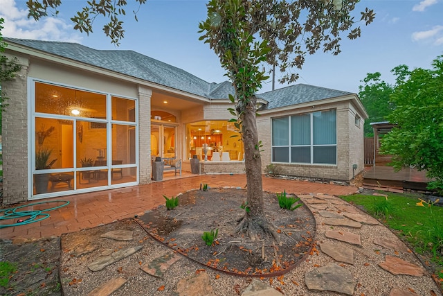 122 Marble Staff Ct, Houston, TX 77069 - rear view of property featuring a patio area, a shingled roof, and brick siding