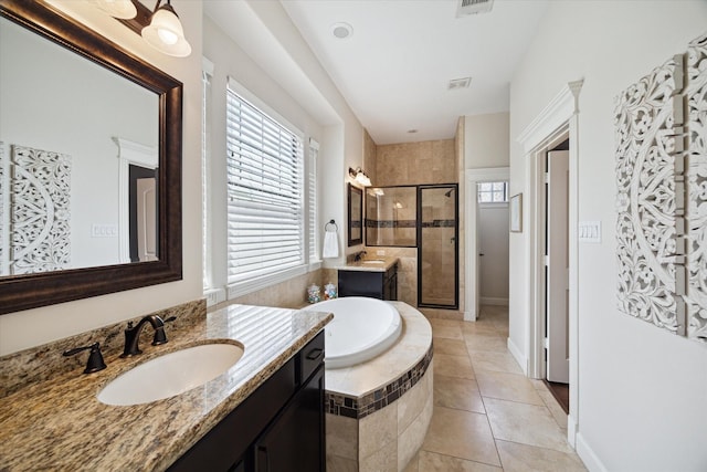 920 Lawrence St Unit D, Houston, TX 77008 - full bathroom with a shower stall, two vanities, a garden tub, and tile patterned flooring