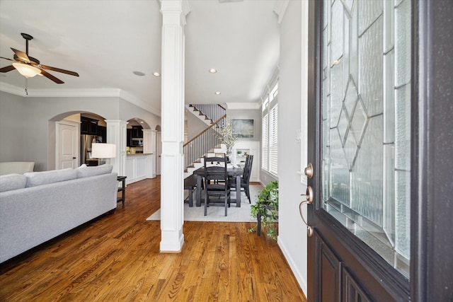 920 Lawrence St Unit D, Houston, TX 77008 - foyer featuring ornamental molding, ceiling fan, ornate columns, wood finished floors, and arched walkways