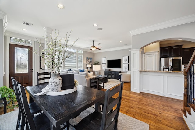 920 Lawrence St Unit D, Houston, TX 77008 - dining room with arched walkways, ornamental molding, ceiling fan, light wood finished floors, and recessed lighting