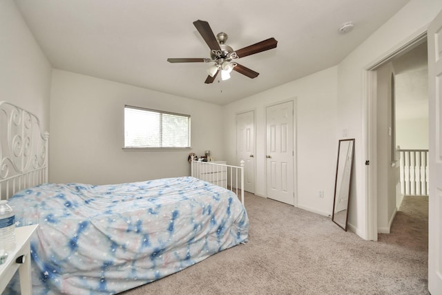 3622 Stratford Town Ln, Sugar Land, TX 77498 - bedroom featuring light carpet, a ceiling fan, and multiple closets
