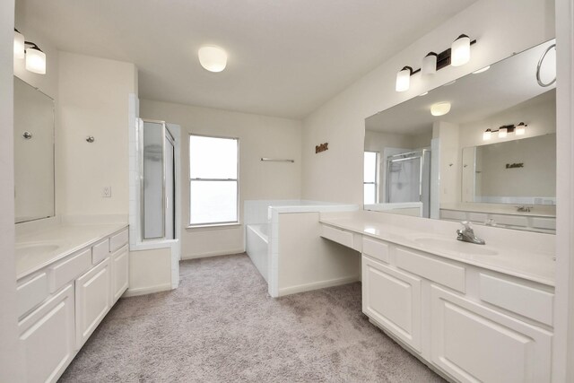 3622 Stratford Town Ln, Sugar Land, TX 77498 - bathroom featuring a stall shower, two vanities, a garden tub, and carpet floors