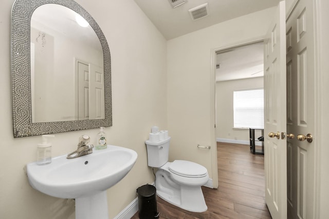 3622 Stratford Town Ln, Sugar Land, TX 77498 - bathroom featuring wood finished floors and toilet