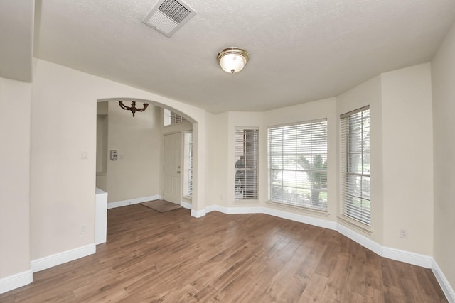 3622 Stratford Town Ln, Sugar Land, TX 77498 - unfurnished room with arched walkways and wood finished floors