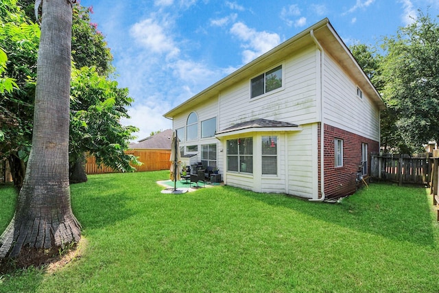 3622 Stratford Town Ln, Sugar Land, TX 77498 - rear view of property featuring brick siding, a fenced backyard, and a patio