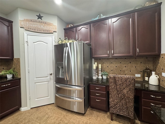 16506 Orchid Mist Dr, Cypress, TX 77433 - kitchen with stainless steel fridge, dark stone counters, and tasteful backsplash