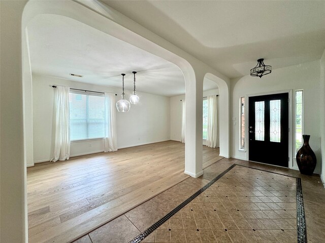 16506 Orchid Mist Dr, Cypress, TX 77433 - foyer entrance with inlaid floor details and arched walkways