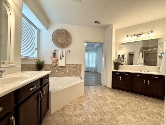 16506 Orchid Mist Dr, Cypress, TX 77433 - full bathroom featuring a stall shower, two vanities, and a garden tub