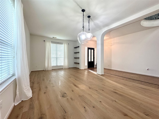 16506 Orchid Mist Dr, Cypress, TX 77433 - unfurnished dining area featuring arched walkways and light wood-type flooring