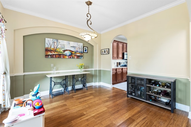 23602 Hawkins Creek Ct, Katy, TX 77494 - dining room with ornamental molding, wood finished floors, and arched walkways