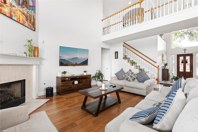 23602 Hawkins Creek Ct, Katy, TX 77494 - living room with a towering ceiling, wood finished floors, stairway, and a fireplace