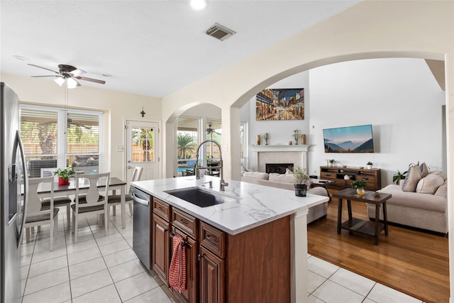 23602 Hawkins Creek Ct, Katy, TX 77494 - kitchen featuring appliances with stainless steel finishes, open floor plan, light tile patterned floors, and ceiling fan