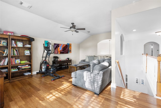23602 Hawkins Creek Ct, Katy, TX 77494 - living area featuring arched walkways, wood finished floors, a ceiling fan, lofted ceiling, and recessed lighting