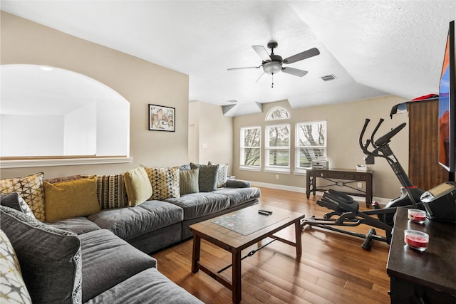 23602 Hawkins Creek Ct, Katy, TX 77494 - living room with ceiling fan, wood finished floors, a textured ceiling, and lofted ceiling