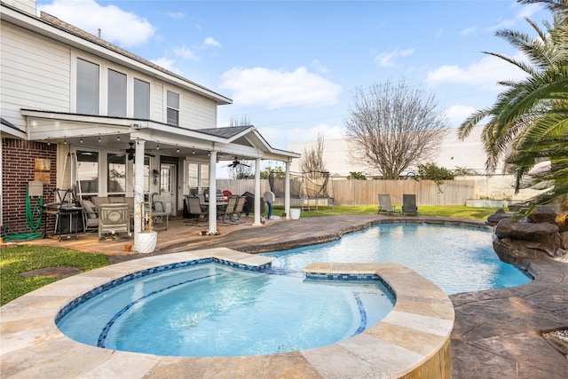 23602 Hawkins Creek Ct, Katy, TX 77494 - view of swimming pool featuring ceiling fan, a fenced backyard, a pool with connected hot tub, and a deck