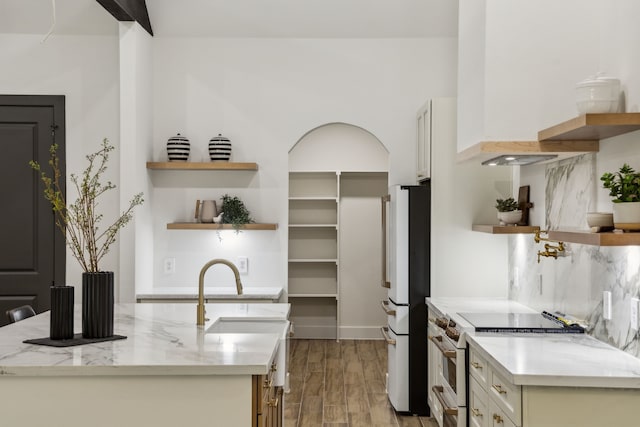 1265 Rd 66112, Dayton, TX 77535 - kitchen featuring open shelves, stainless steel range, wood finished floors, and freestanding refrigerator
