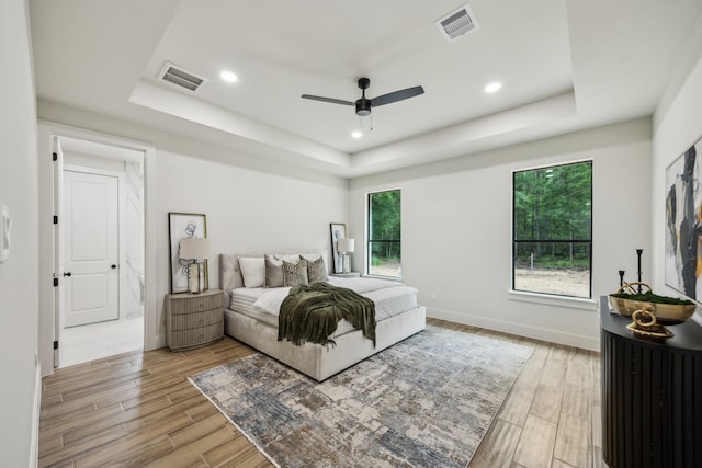 1265 Rd 66112, Dayton, TX 77535 - bedroom featuring a tray ceiling, light wood-type flooring, recessed lighting, and a ceiling fan