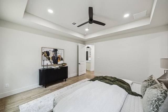 1265 Rd 66112, Dayton, TX 77535 - bedroom featuring a raised ceiling, wood finished floors, arched walkways, recessed lighting, and ceiling fan