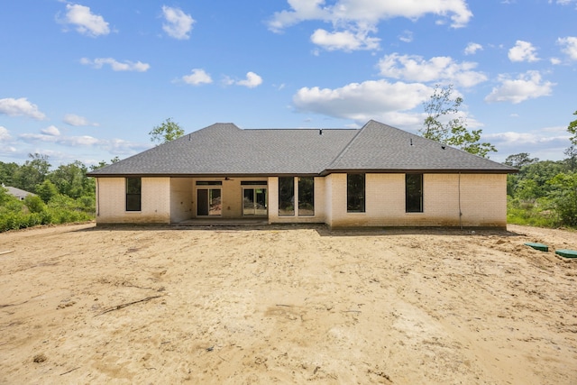 1265 Rd 66112, Dayton, TX 77535 - back of house featuring brick siding, roof with shingles, and a patio