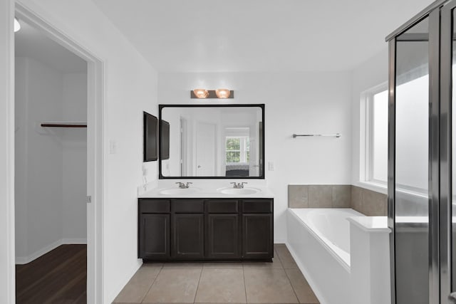 19210 Kent Park Dr, Tomball, TX 77375 - bathroom featuring a garden tub, double vanity, and tile patterned flooring