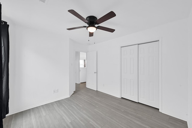 19210 Kent Park Dr, Tomball, TX 77375 - unfurnished bedroom featuring wood finished floors, a closet, and a ceiling fan