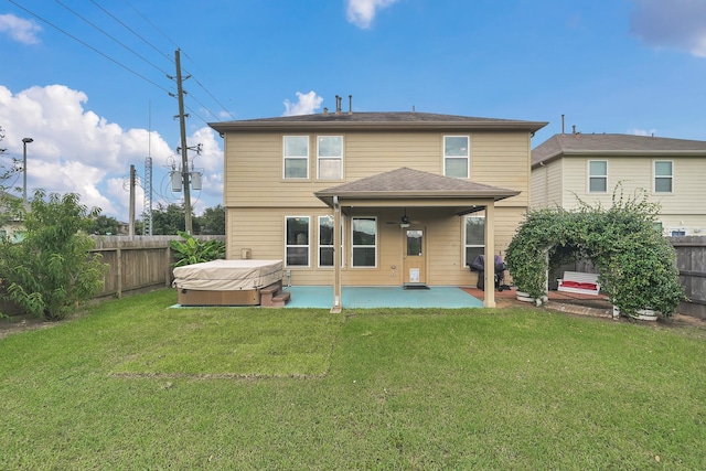 19210 Kent Park Dr, Tomball, TX 77375 - back of house with a hot tub, a patio area, a fenced backyard, and a ceiling fan