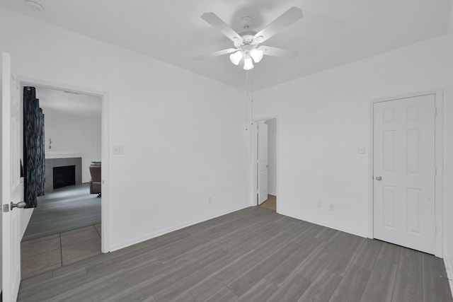 19210 Kent Park Dr, Tomball, TX 77375 - spare room with ceiling fan, wood finished floors, and a fireplace
