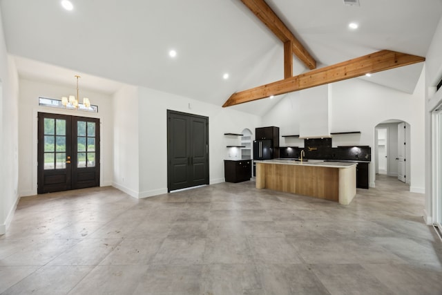 1253 Rd 66112, Dayton, TX 77535 - kitchen featuring recessed lighting, a kitchen island with sink, french doors, high vaulted ceiling, and arched walkways