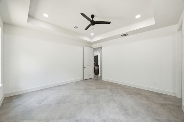 1253 Rd 66112, Dayton, TX 77535 - spare room featuring a raised ceiling, ceiling fan, recessed lighting, arched walkways, and concrete flooring